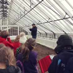 Phil, Head Gardener at Trengwainton explains to Trythall School about the Victorian greenhouse